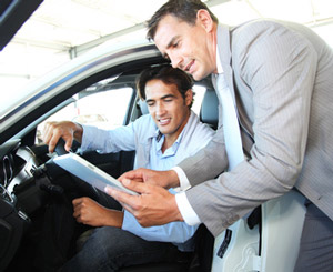 man in car checking documents