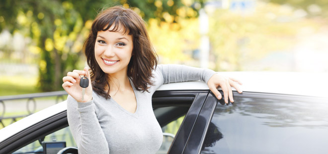 woman buying a car and smiling